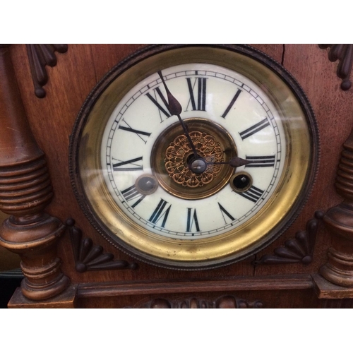 503 - AN OAK MANTLE CLOCK WITH PENDULUM