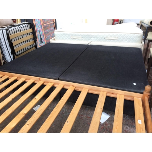 564 - A BLACK FABRIC DOUBLE BED FRAME WITH TWO DRAWERS