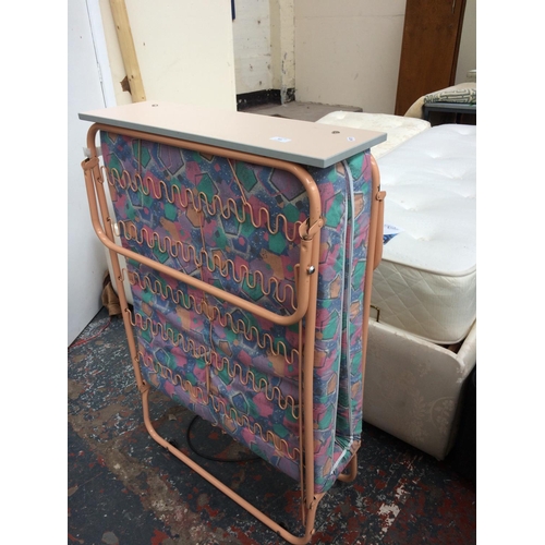 569 - A JAYBE FOLDING BED WITH PINK FRAME AND MULTICOLOURED MATTRESS