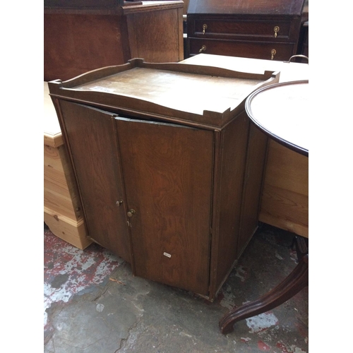 577 - AN OAK TWO DOOR CABINET