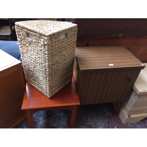 579 - THREE ITEMS: A TEAK EFFECT SEWING CABINET, YEW WOOD COFFEE TABLE AND A WICKER CORNER LAUNDRY BASKET