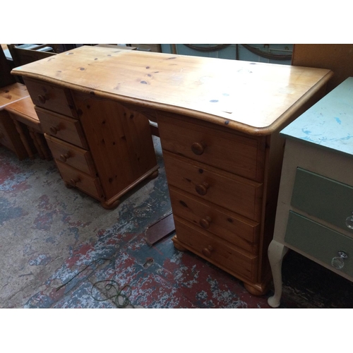 583 - THREE ITEMS: A PINE DRESSING TABLE WITH EIGHT DRAWERS, PINE NEST OF THREE TABLES AND A SMALL PINE CH... 