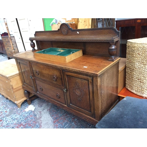 597 - A LARGE VINTAGE OAK SIDEBOARD WITH TWO DRAWERS AND TWO DOORS