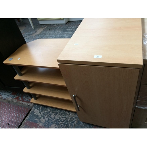 653 - TWO ITEMS: A BEECH EFFECT SINGLE DOOR CABINET AND A WOOD EFFECT TV STAND