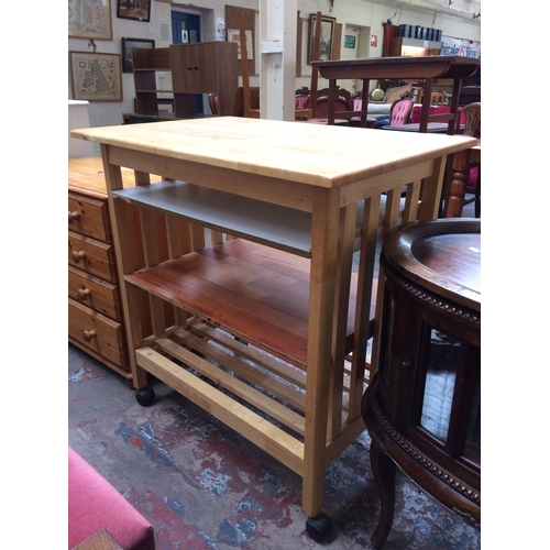 658 - AN OAK KITCHEN TROLLEY ISLAND WITH FITTED SHELVING ON CASTERS