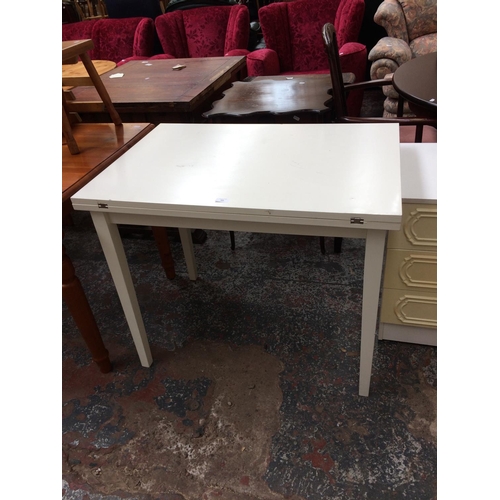 666 - A WHITE LAMINATE KITCHEN FOLD OUT TABLE