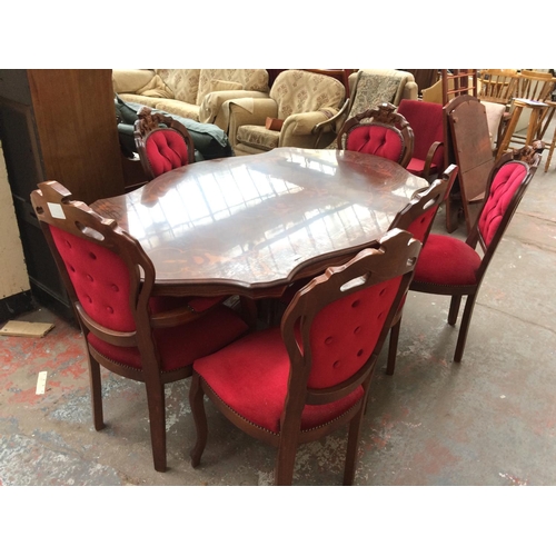 674 - A LARGE MAHOGANY SERPENTINE DINING TABLE AND SIX MATCHING RED BUTTON BACK CHAIRS