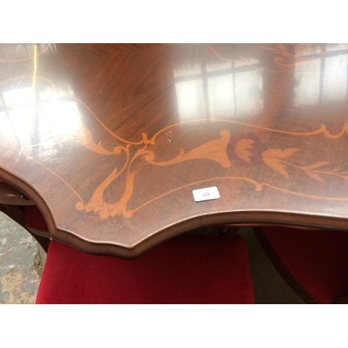 674 - A LARGE MAHOGANY SERPENTINE DINING TABLE AND SIX MATCHING RED BUTTON BACK CHAIRS