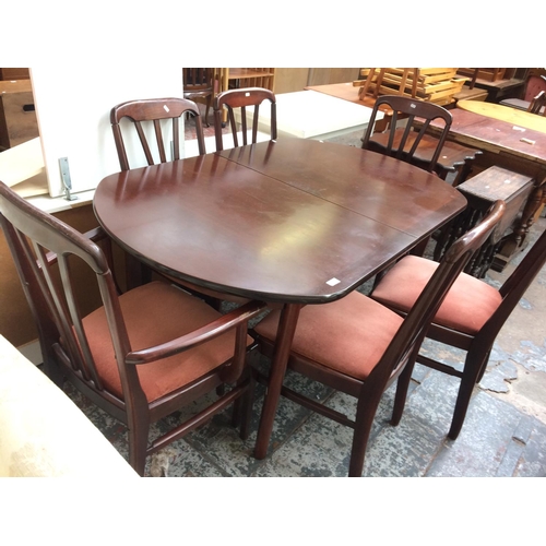 677 - A MAHOGANY OVAL EXTENDING DINING TABLE AND SIX MATCHING CHAIRS