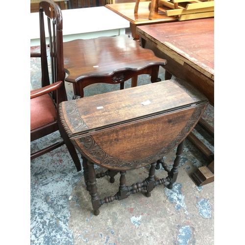 678 - TWO ITEMS: A VINTAGE OAK DROP LEAF DINING TABLE AND A MAHOGANY SERPENTINE CONSOLE TABLE