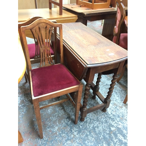 680 - A VINTAGE OAK BARLEY TWIST DROP LEAF DINING TABLE AND TWO MATCHING CHAIRS