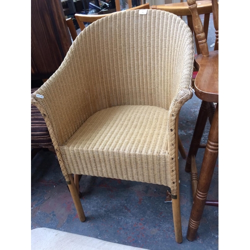 710 - A LLOYD LOOM STYLE WICKER CHAIR, TWO PINE KITCHEN STOOLS AND TWO PINE KITCHEN CHAIRS