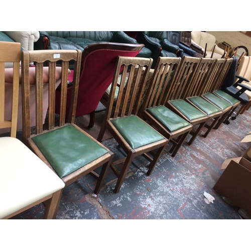 715 - SEVEN VINTAGE OAK DINING CHAIRS WITH GREEN LEATHERETTE SEATS