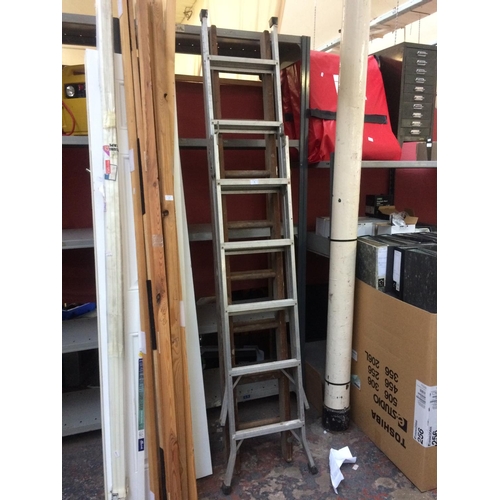 76 - TWO ITEMS TO INCLUDE A SET OF DOUBLE EXTENDABLE SIXTEEN RUNG WOODEN LADDERS AND A MULTI PURPOSE ALUM... 