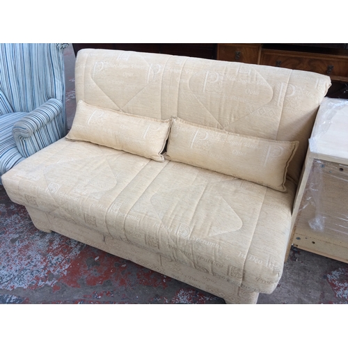 650A - A GOLD TAPESTRY TWO SEATER BED SETTEE