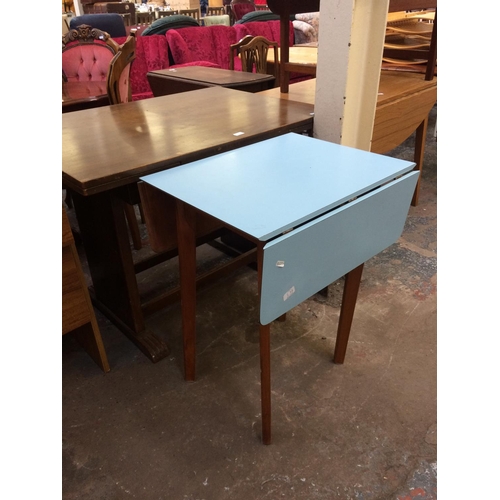 663 - TWO ITEMS: A MAHOGANY EFFECT PULL OUT DINING TABLE AND A BLUE LAMINATE DROP LEAF KITCHEN TABLE