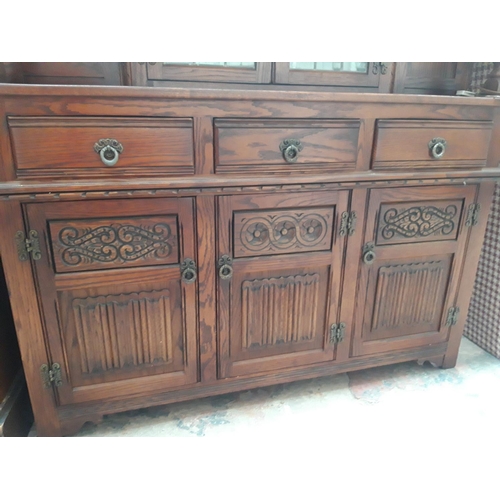 1119 - AN ANTIQUE STYLE TIGER OAK COURT CUPBOARD WITH THREE LOWER DOORS, THREE DRAWERS AND TWO UPPER GLAZED... 