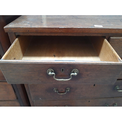 1122 - A GEORGIAN OAK CHEST OF TWO SHORT AND THREE LONG DRAWERS WITH BRASS SWAN NECK HANDLES