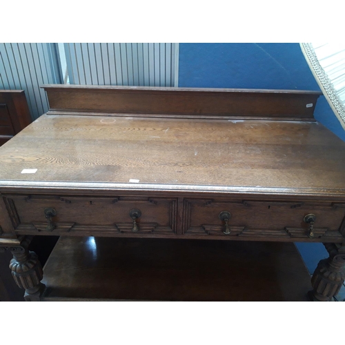 1124 - A GOOD QUALITY 20TH CENTURY CARVED OAK BUFFET WITH TWO LOWER DOORS, TWO UPPER DRAWERS WITH BRASS TEA... 