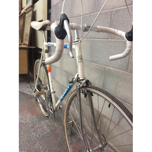 1110 - A VINTAGE 1980'S MULTI COLOURED PEUGEOT TRIATHLON MEN'S RACING BIKE WITH QUICK RELEASE WHEELS AND 12... 