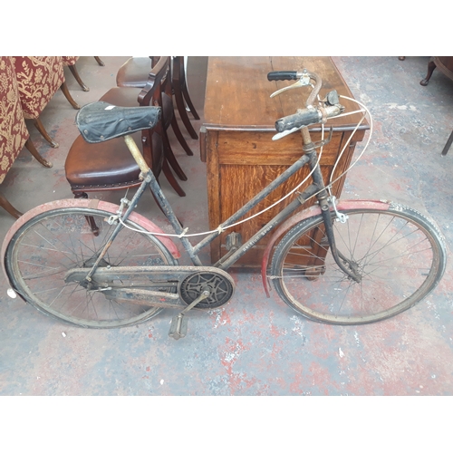 1110B - A VINTAGE BLACK AND RED RALEIGH SPORTS LADIES TOWN BIKE WITH DYNAMO REAR WHEEL AND 3 SPEED GEAR SYST... 