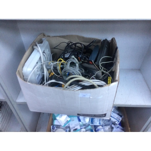 203 - A BOX CONTAINING BT LANDLINE PHONE AND WIRELESS ROUTER, VARIOUS POWER PACKS, LEADS ETC