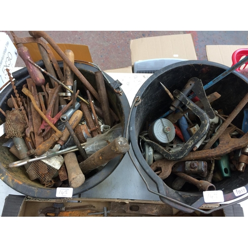 143 - TWO BUCKETS AND A BOX CONTAINING LARGE MASONRY DRILL BITS, RECORD G-CLAMP, SPANNERS, FILES, HAMMERS ... 