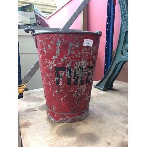 64 - A VINTAGE GALVANISED FIRE BUCKET CONTAINING METAL MONEY BOX AND A PAIR OF CATTLE RESTRAINTS