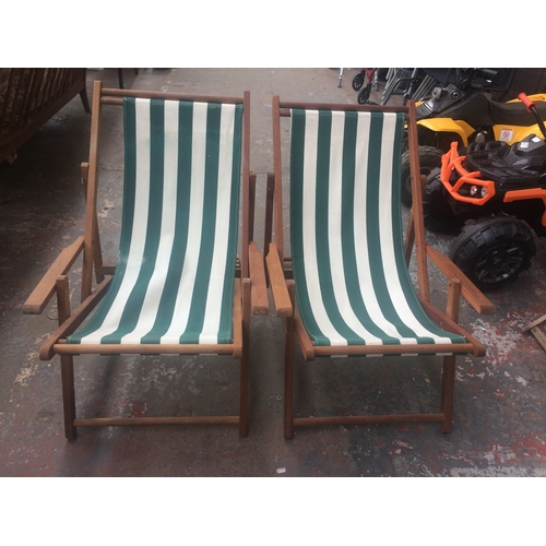 25 - A MATCHING PAIR OF WOODEN DECK CHAIRS