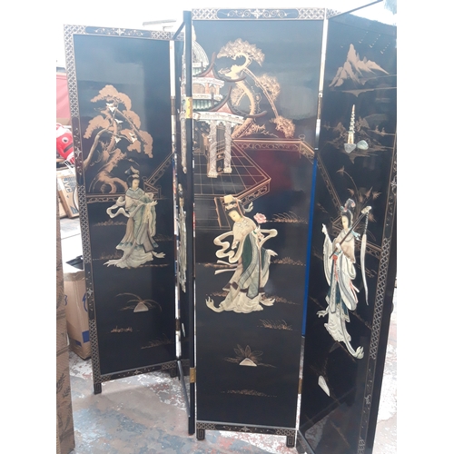 1119C - A BLACK LACQUERED FOUR FOLD OUT ORIENTAL DRESSING SCREEN