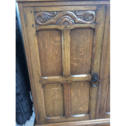 237 - A GOOD QUALITY GOLDEN OAK CABINET WITH THREE DOORS AND THREE DRAWERS SET UPON A STRETCHER BASE (MEAS... 