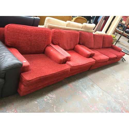 427 - A RED UPHOLSTERED THREE SEATER SOFA AND TWO MATCHING ARMCHAIRS