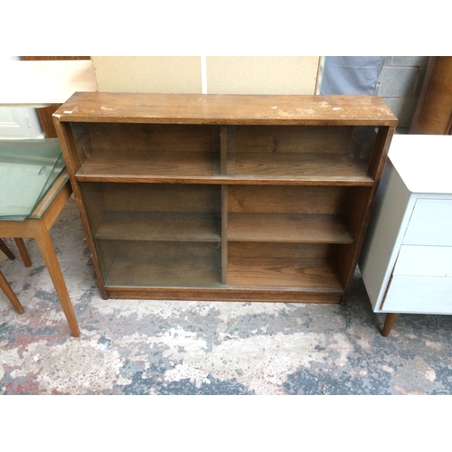 336 - NINE ITEMS TO INCLUDE AN OAK BOOKCASE WITH GLASS SLIDING DOORS, WHITE PAINTED CHEST OF THREE DRAWERS... 