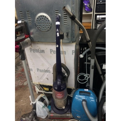 212 - A BLUE BISSELL UPRIGHT CYLINDER BAGLESS VACUUM CLEANER