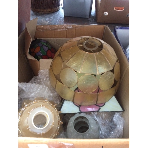 385 - TWO BOXES CONTAINING MIXED ITEMS TO INCLUDE: TEAPOTS, TIFFANY STYLE LAMPSHADE, GLASS BOTTLES, ETC