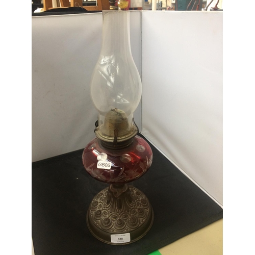 428 - VICTORIAN OIL LAMP WITH CUT CRANBERRY GLASS RESERVOIR AND EMBOSSED BRASS BASE