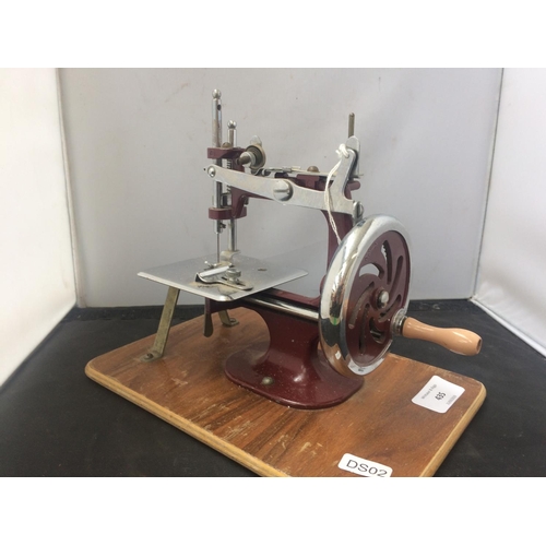 435 - 20th CENTURY SMALL CHILDS RED METAL SEWING MACHINE