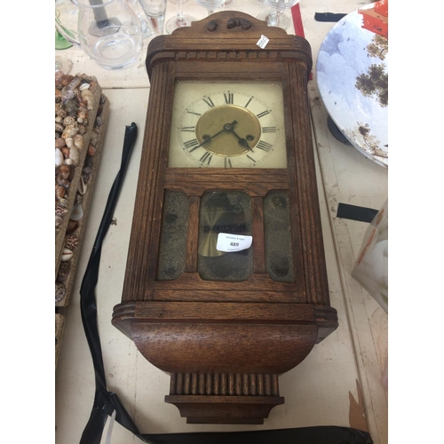 489 - VINTAGE OAK CASED CHIMING WALL CLOCK WITH KEY AND PENDULUM