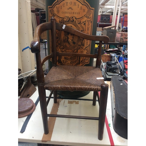 510 - EARLY 20th CENTURY ELM FRAMED CHILDS CORNER CHAIR WITH RUSH SEAT