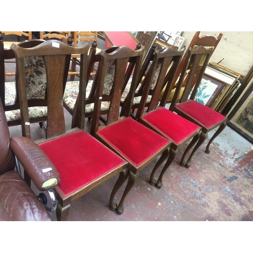 815 - A SET OF FOUR VICTORIAN OAK FRAMED DINING CHAIRS ON CABRIOLE SUPPORTS WITH RED VELVET UPHOLSTERED SE... 