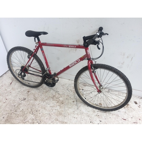 9 - A RED SUZICO  EAGLE GENTS MOUNTAIN BIKE WITH QUICK RELEASE FRONT WHEEL AND 21 SPEED SHIMANO GEAR SYS... 