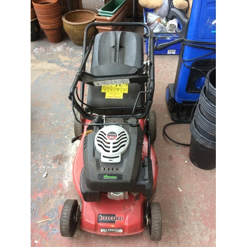 173 - A BLACK AND RED CHAMPION PETROL SELF PROPELLED LAWN MOWER WITH GRASS COLLECTOR (W/O)