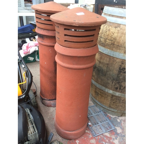 177 - A PAIR OF TERRACOTTA CHIMNEY POTS WITH BIRD GUARDS