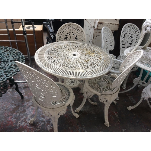 26 - FOUR ITEMS TO INCLUDE A WHITE PAINTED CAST ALUMINIUM CIRCULAR PATIO TABLE AND THREE MATCHING CHAIRS