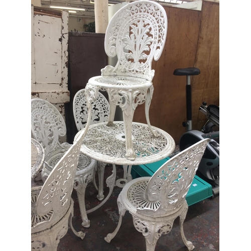 27 - FIVE ITEMS TO INCLUDE WHITE PAINTED CAST ALUMINIUM ORNATE PATIO TABLE AND FOUR MATCHING CHAIRS