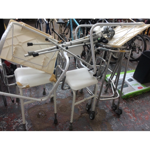 34 - A LARGE SELECTION OF MOBILITY EQUIPMENT TO INCLUDE BED TABLE, ALUMINIUM WALKING AIDS, SHOWER SEAT ET... 