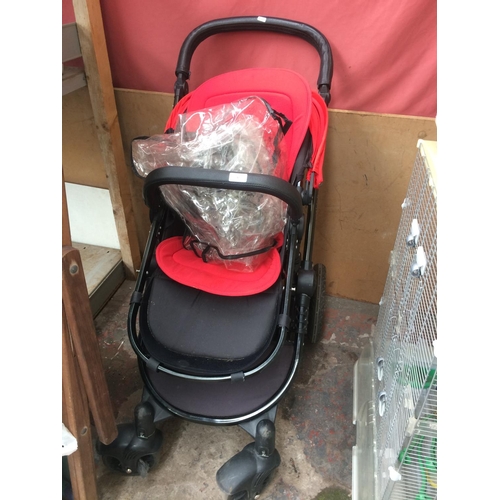 37 - A BLACK AND RED ICKLE BUBBA CHILD'S PUSH CHAIR WITH RAIN COVER