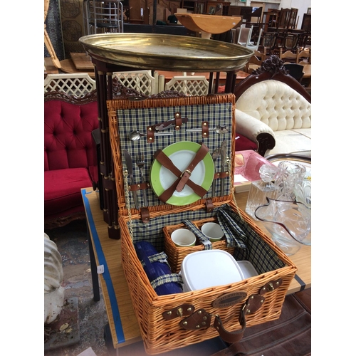 373 - TWO ITEMS TO INCLUDE A SHERWOOD OUTDOORS WICKER HAMPER BASKET WITH CONTENTS AND A BRASS SERVING TRAY... 