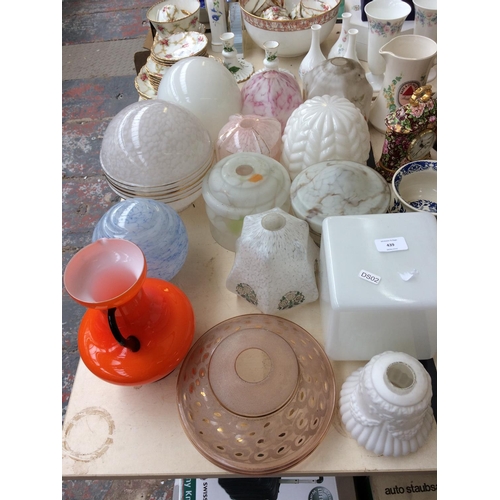 439 - THIRTEEN VARIOUS VINTAGE GLASS LAMPSHADES AND A 1970's ORANGE GLASS JUG