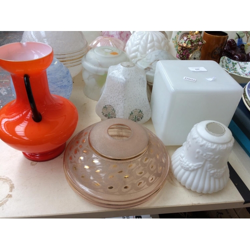 439 - THIRTEEN VARIOUS VINTAGE GLASS LAMPSHADES AND A 1970's ORANGE GLASS JUG